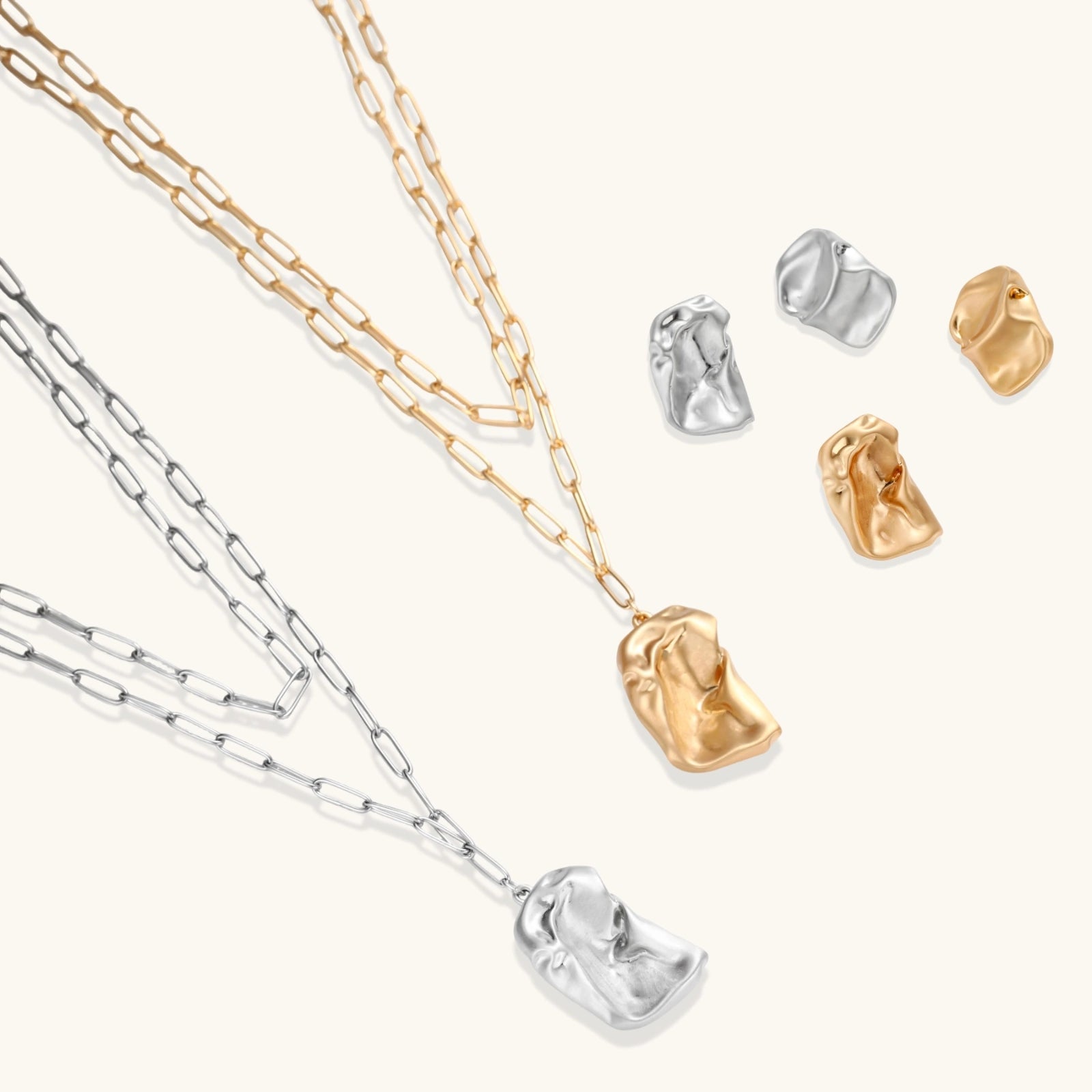Modern textured hoop earrings and layered chain necklace with liquid metal pendant in silver and gold finishes.